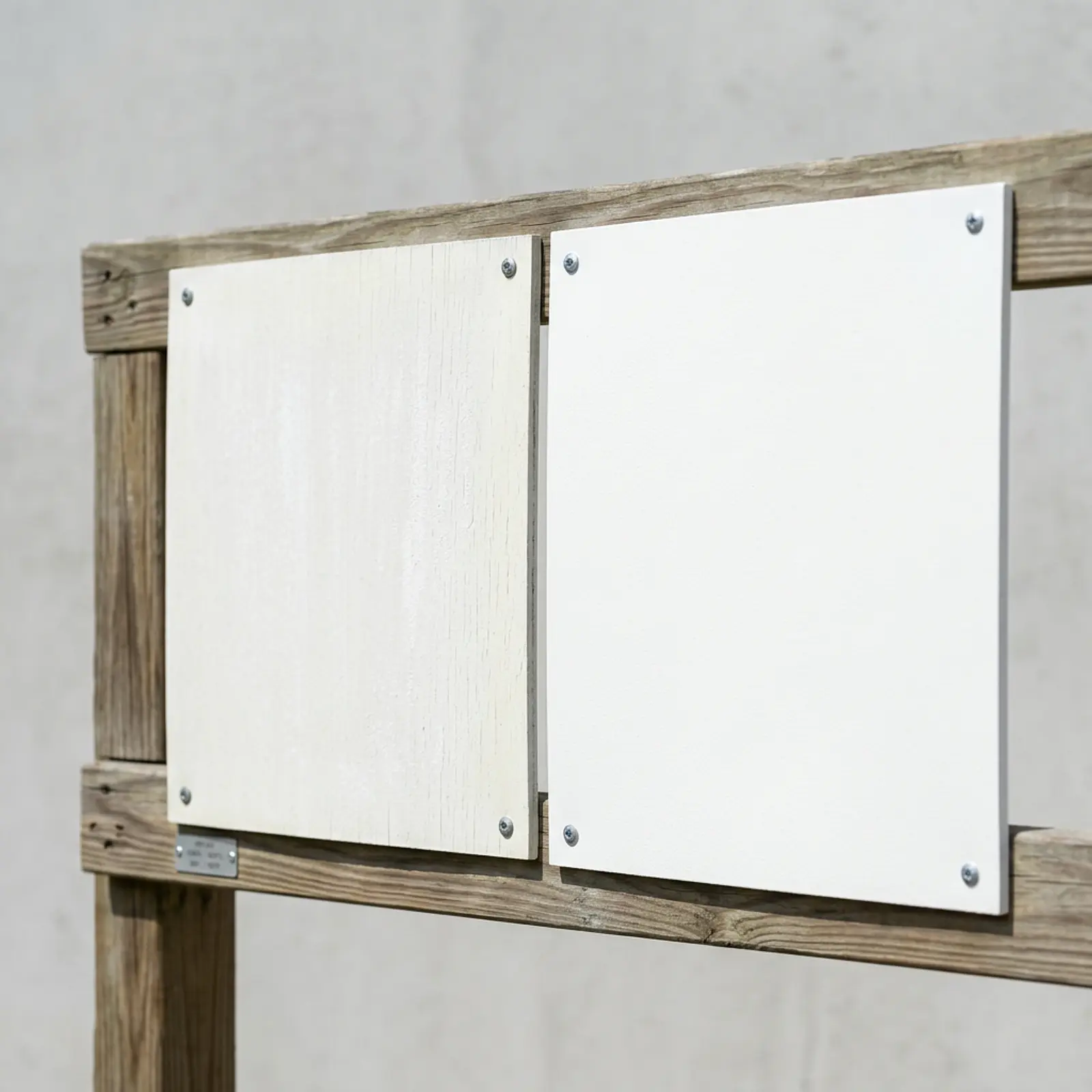 Photorealistic outdoor test fence showing two UV-weathered white wall panels, side by side with macro detail